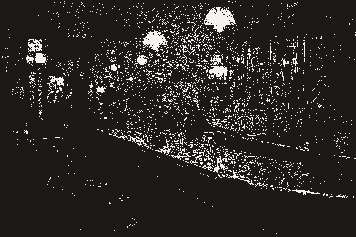 A dim, mirrored Paris bar interior, bottles lining the back wall
